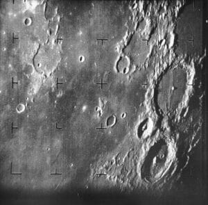 Black and white image of the Moon’s surface with many craters and crosshair markers, taken by a lunar spacecraft.