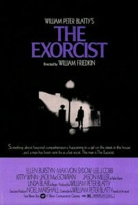 Poster for The Exorcist shows a man with a hat and briefcase standing under a streetlight outside a house at night, with the films title in large purple letters above.