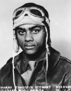 Black-and-white portrait of a young Black male pilot in vintage flight gear; partial identifying text appears at the bottom.