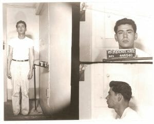 1963 black-and-white mugshots of a man in white shirt and light pants with front, side, profile views. Sign: PD Phoenix Ariz 446540.
