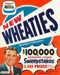 Vintage Wheaties cereal box with $100,000 Outdoor Living Sweepstakes, 2,555 prizes, a smiling man in a suit, and General Mills logo.