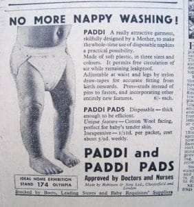 A vintage newspaper ad features a baby wearing reusable and disposable Paddi pads, promoting an alternative to washing nappies. Text describes product features and benefits, with a black-and-white photo of a baby in the pads.