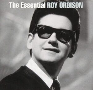 Black and white album cover shows Roy Orbison wearing dark sunglasses and a suit, smiling. Text at the top reads The Essential ROY ORBISON.
