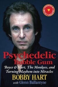 Book cover showing a serious-faced man with blue eyes and dark hair in front of a dark background. Title: Psychedelic Bubble Gum by Bobby Hart with Glenn Ballantyne; includes a red foreword label by Micky Dolenz.